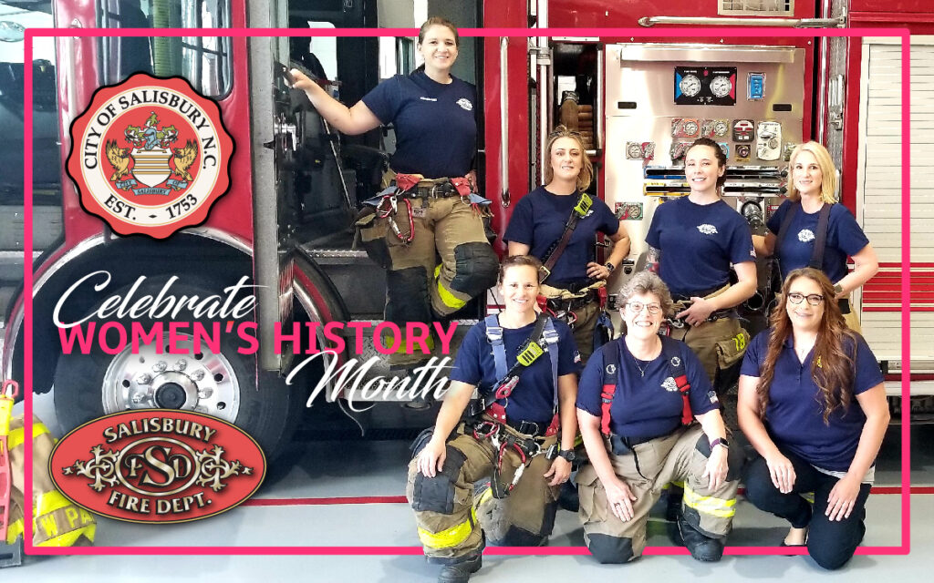 Celebrate Women's History month: Group of female firefighters in uniform posed inf front of a firetruck, smiling at camera.